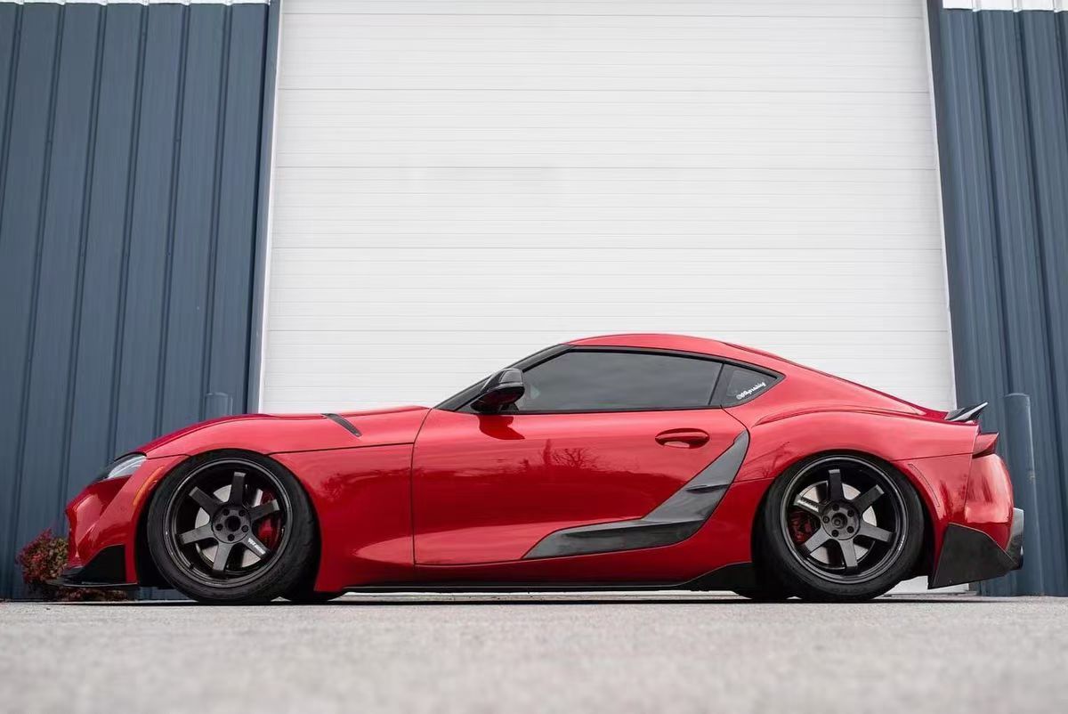 TRD-style carbon fiber door panel trim for Supra A90/A91