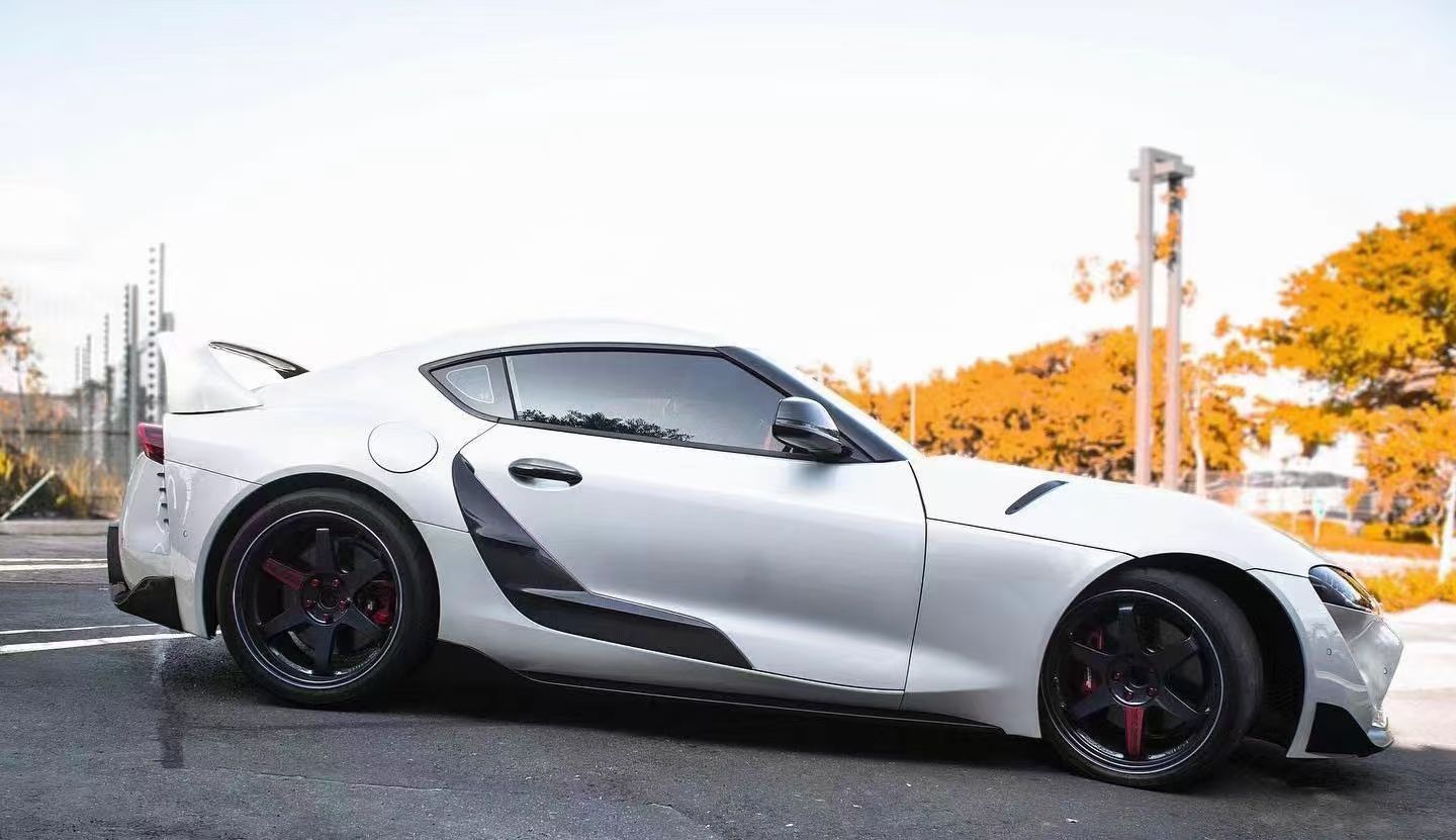 TRD-style carbon fiber door panel trim for Supra A90/A91