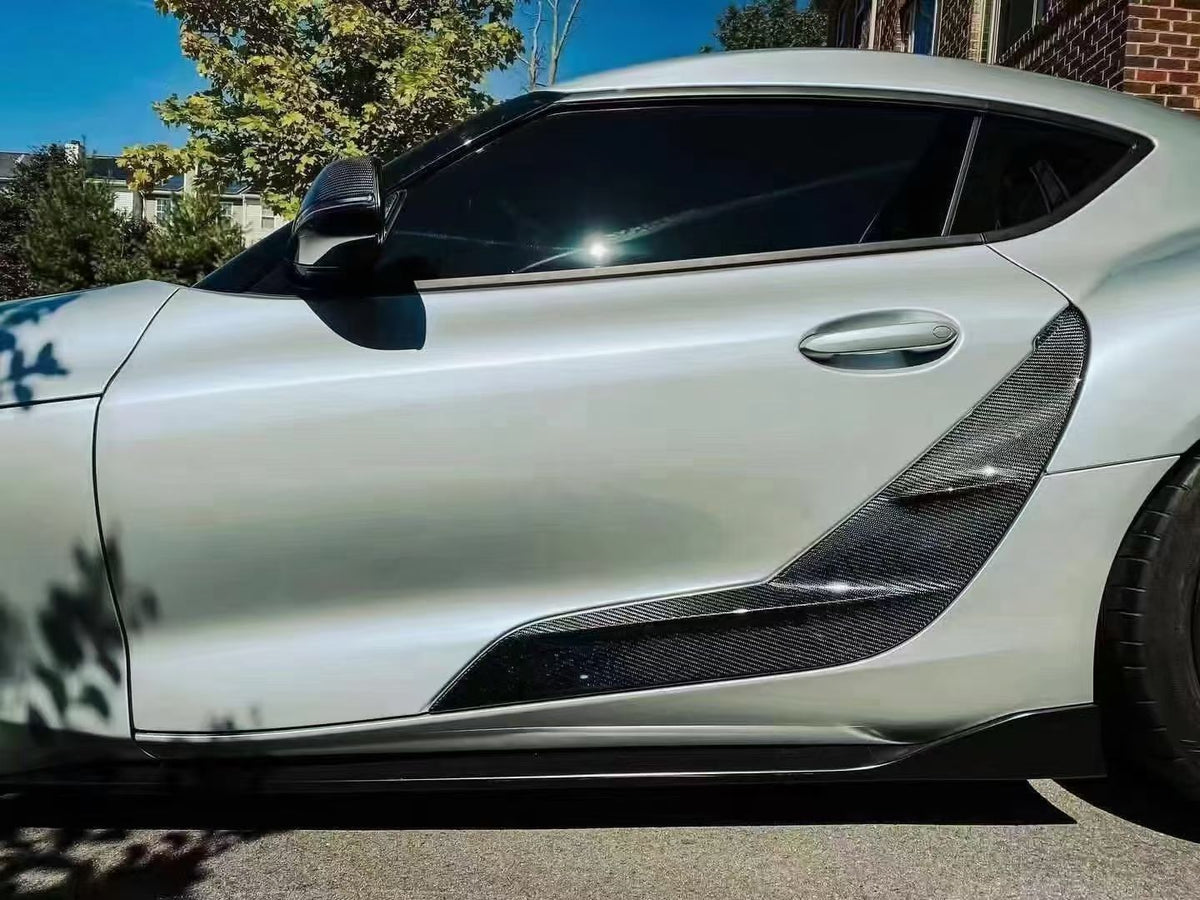 TRD-style carbon fiber door panel trim for Supra A90/A91