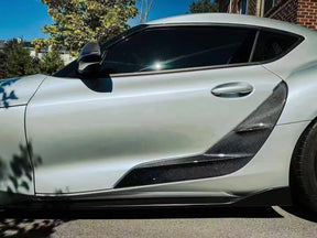 TRD-style carbon fiber door panel trim for Supra A90/A91